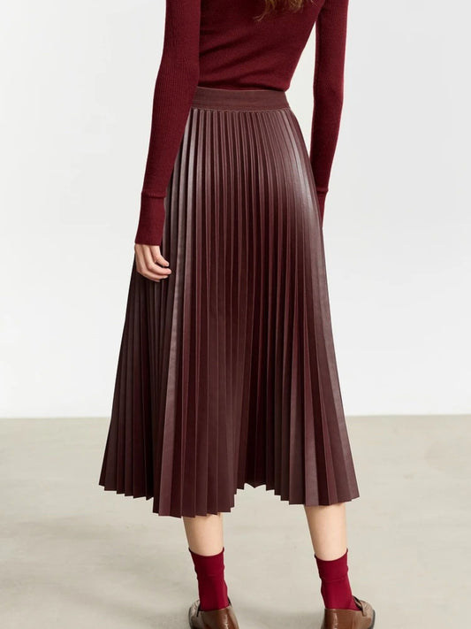 Back view of burgundy faux leather pleated midi skirt paired with burgundy long-sleeve top