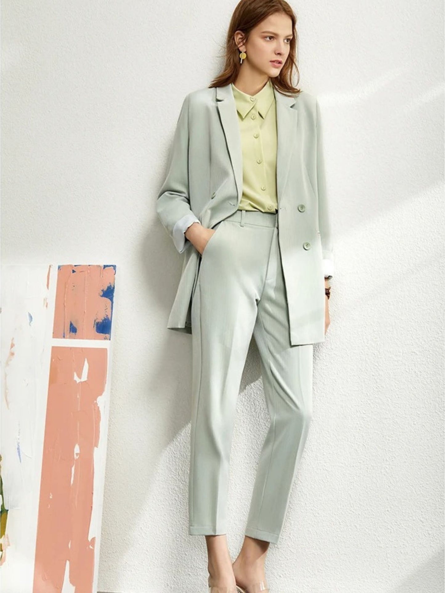 Light beige pantsuit with notched collar, rolled sleeves, and matching straight-leg trousers