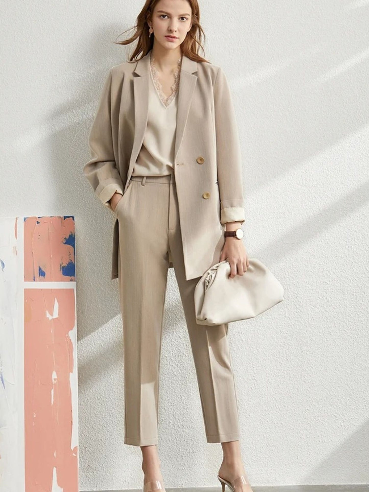 Beige double-breasted blazer with notched lapel and front pockets laid flat
