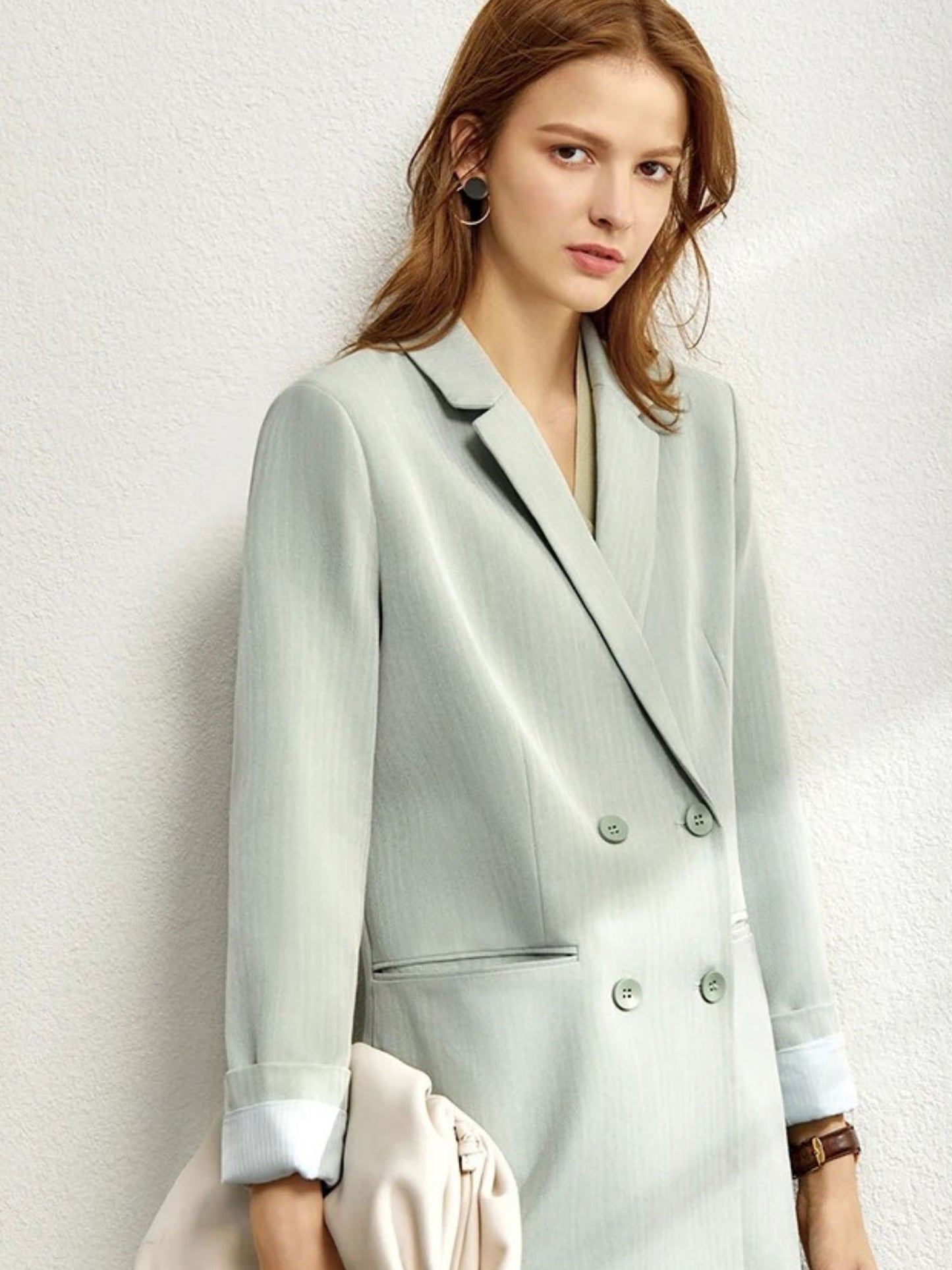 Sage green double-breasted blazer and trousers styled with neutral accessories