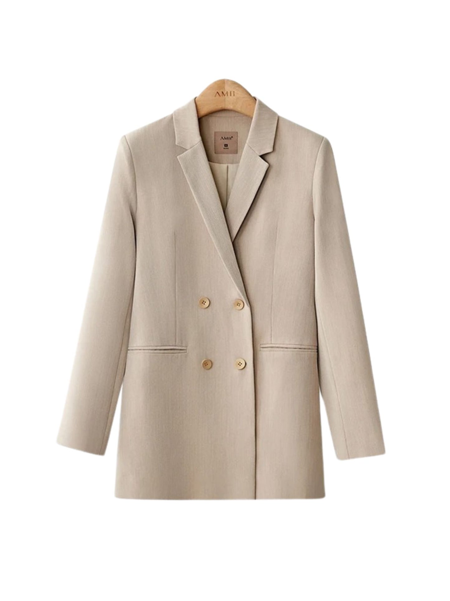 Mustard yellow tailored suit with white blouse, worn with hands in pockets and casual stance