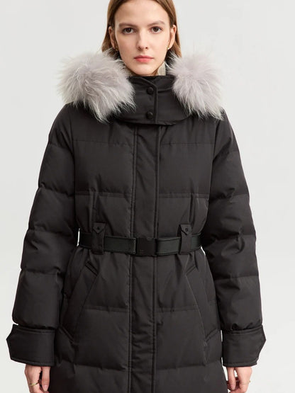 Black version of the coat, front view with fur trim on the hood. The model stands with hands in pockets