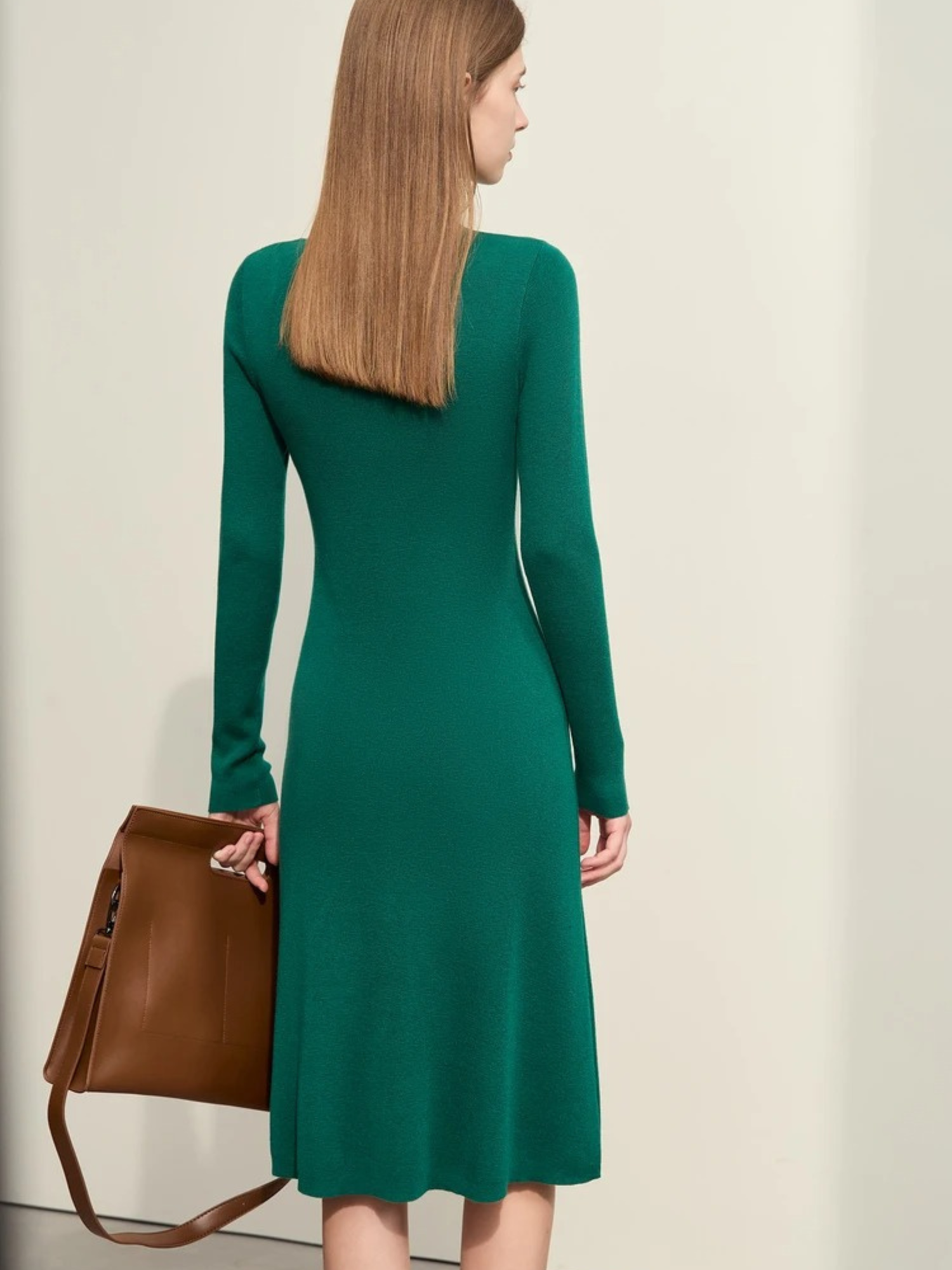 Back view of green long-sleeve midi dress with fitted shape and crew neckline