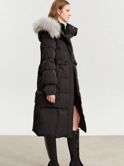 Side-back view of the black coat with the fur-trimmed hood. The model's hair is tucked inside the collar