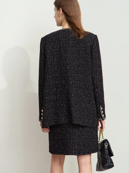 Rear view of the model in the same outfit, showing the full back of the jacket and skirt. The jacket has a boxy, slightly oversized silhouette