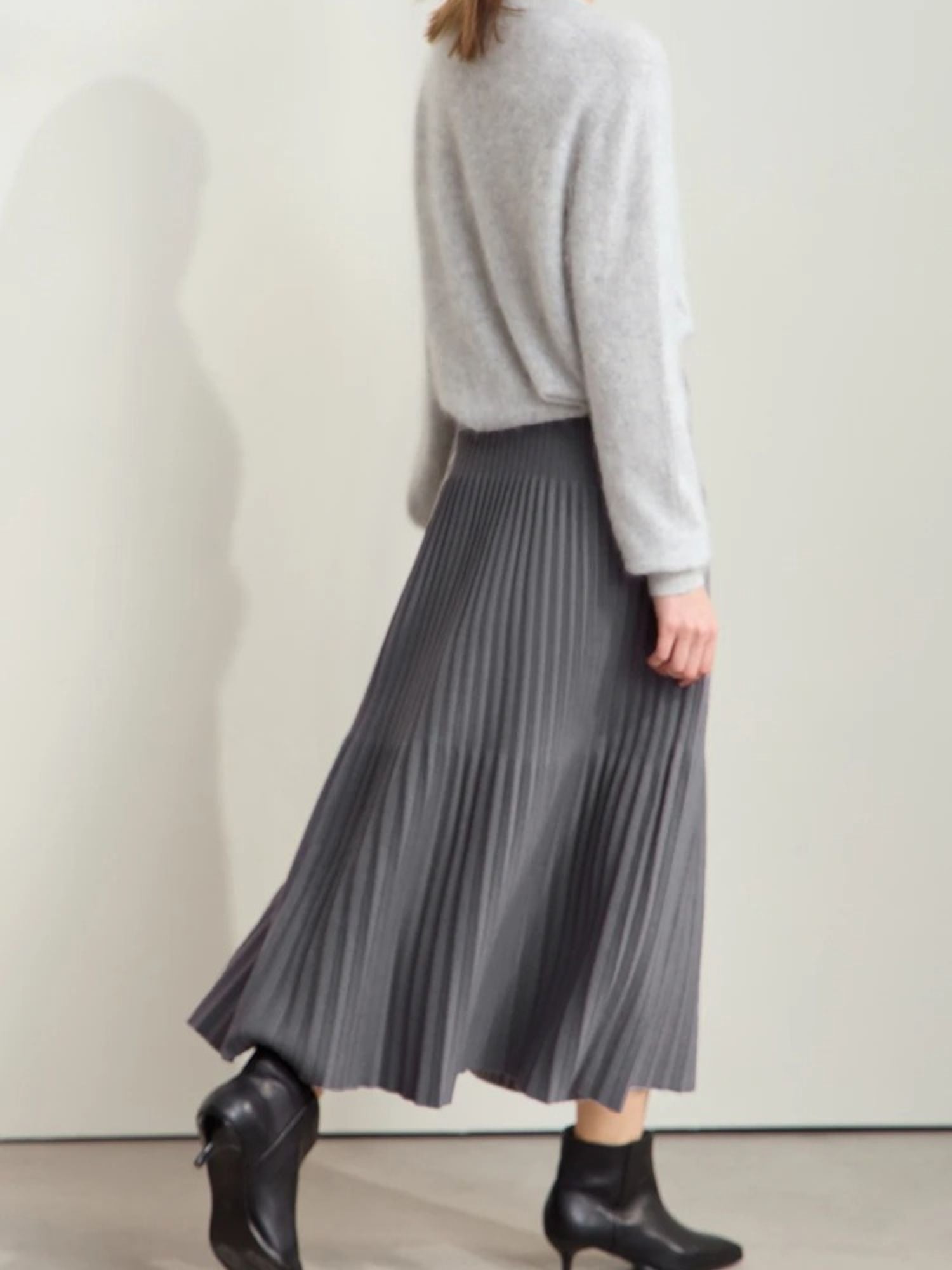 Back side view of gray pleated midi skirt with color-block detail