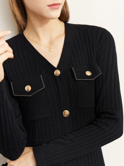 Close-up of black ribbed knit midi dress showing gold buttons and chest pocket details