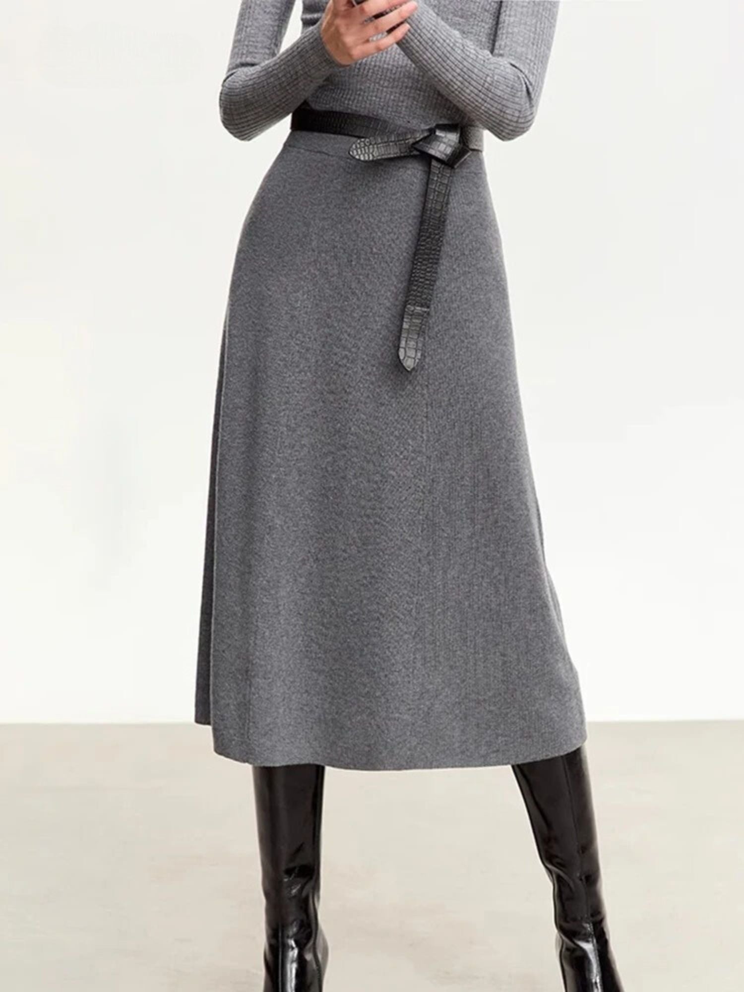 Gray dress with a belt worn by a person on a white background