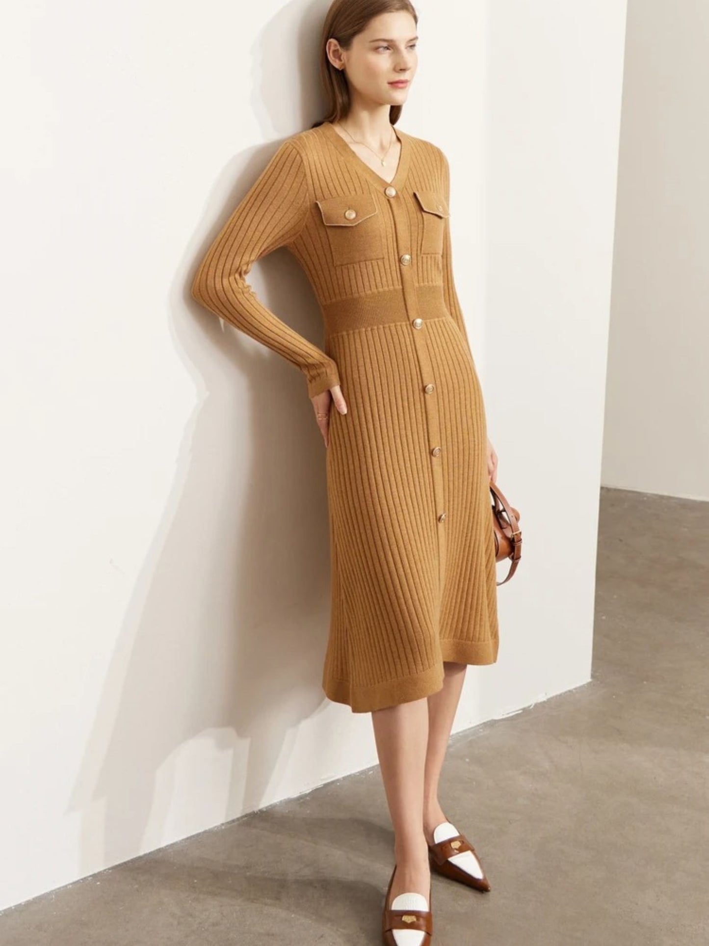 Side view of camel ribbed knit midi dress with long sleeves, button-front closure, and chest pockets