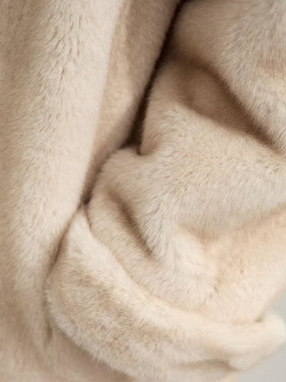 Extreme close-up of the coat fabric, revealing its brushed wool texture in detail. The material looks cozy and plush