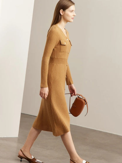 Model walking in camel ribbed knit midi dress with long sleeves, button-front closure, and chest pockets