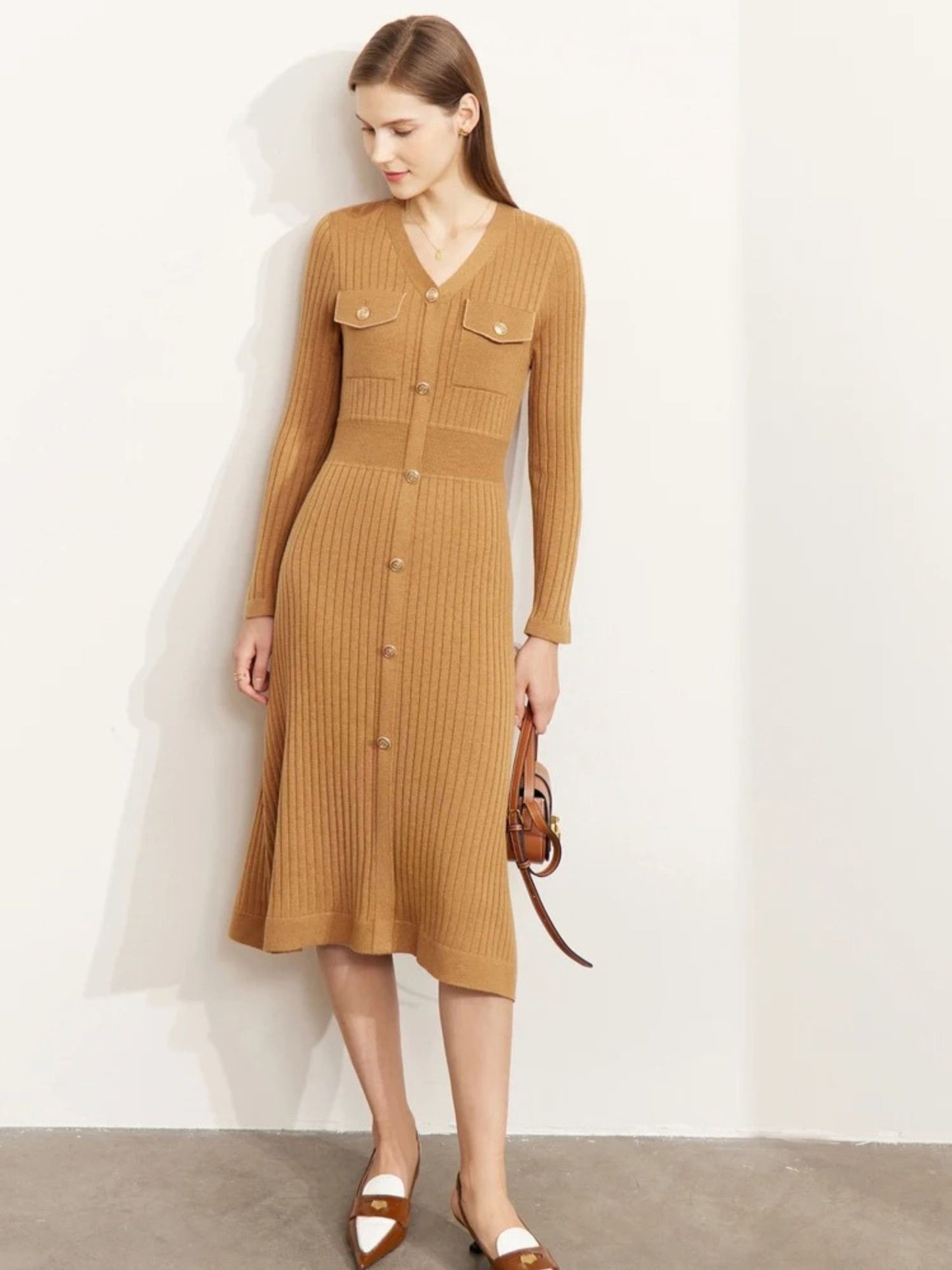 Front view of camel ribbed knit midi dress with long sleeves, gold buttons, and chest pockets