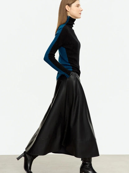 Side profile of woman in black midi leather skirt showing soft sheen and flowy silhouette