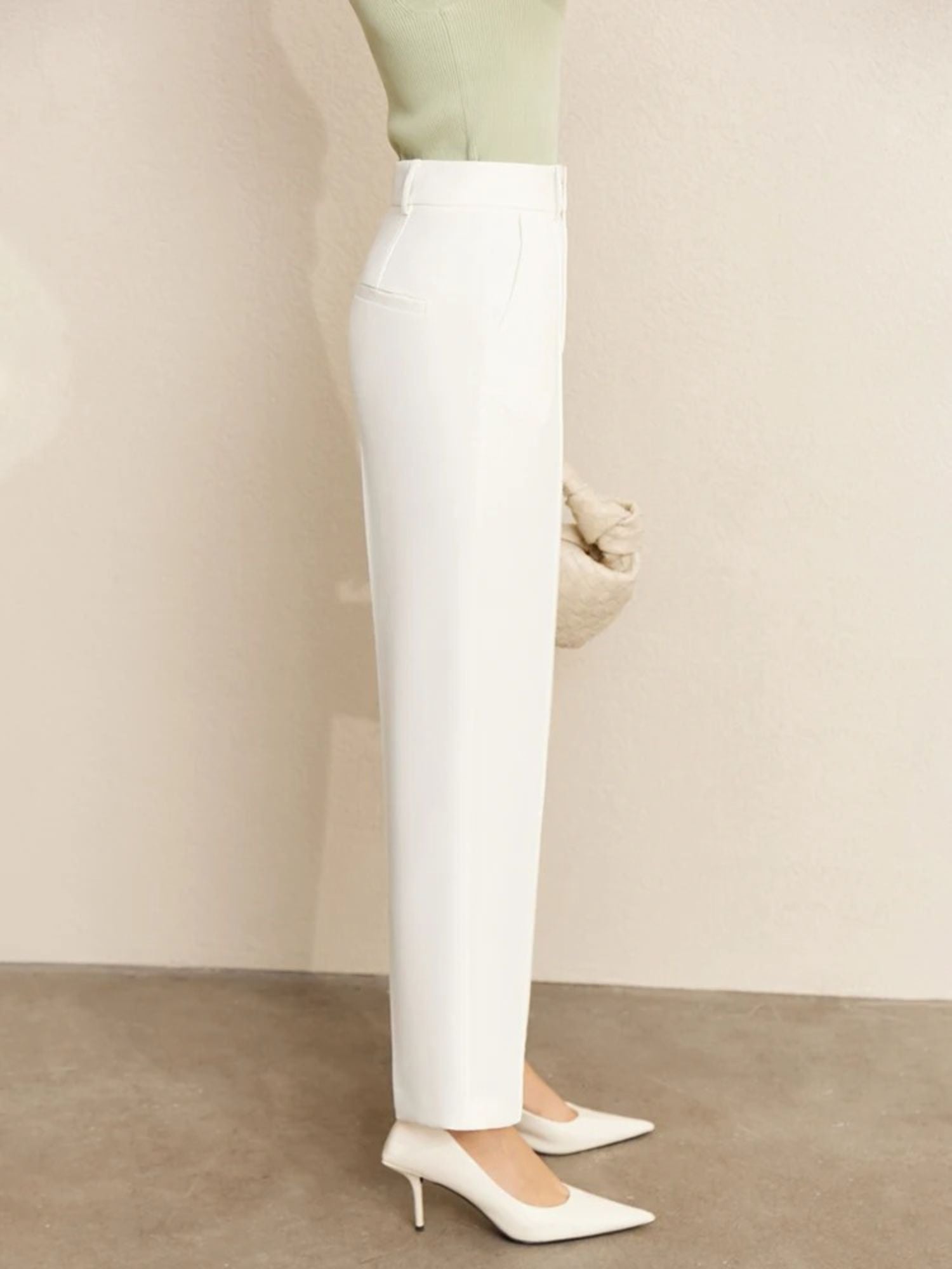 Rear view of white tailored pants showing clean seams and cropped hem