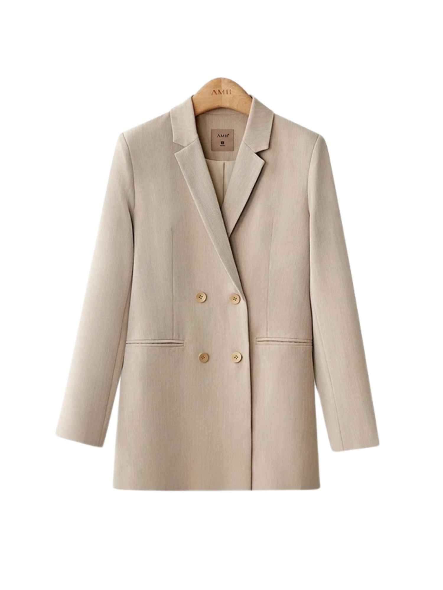 Mustard yellow tailored suit with white blouse, worn with hands in pockets and casual stance